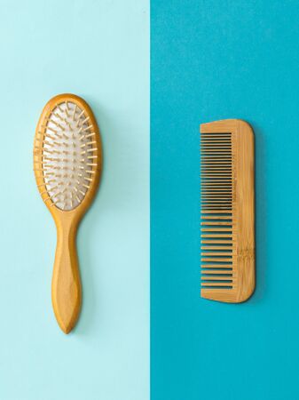 Set of wooden combs on a blue and blue background. Device for combing hair.の写真素材
