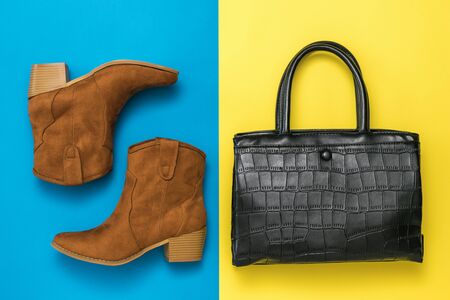 Leather bag and suede boots on a yellow and blue background. A set of women 's accessories. Flat lay.の写真素材