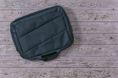 Large laptop bag on tinted wooden boards. Accessory for your laptop.