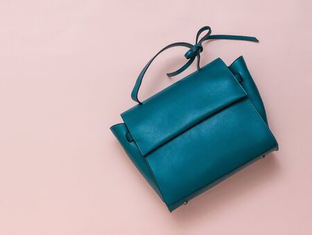 Bag made of dark turquoise leather on a pastel background. The view from the top. Flat lay.の写真素材