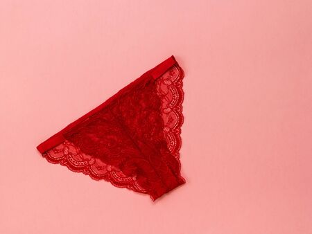 Blue panties with red and white heart on pink background. Underwear. The view from the top....