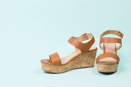 Summer leather sandals on a blue background. Summer shoes for women.