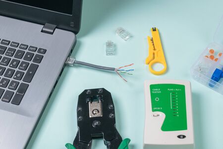 The process of connecting an rj 45 cable to a laptop. Connection to the Internet.