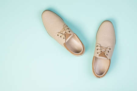 Men's leather shoes with laces on a light blue background. Summer men's shoes.の写真素材