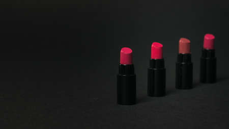 A number of lipstick samples on a black background. Cosmetics for lips.の写真素材