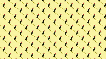 Background of small tubes of lipstick on a yellow background. Cosmetics for lips.の写真素材