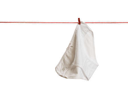 Clean white women's panties on a clothesline isolated on a white background. Drying clothes after washing.の写真素材