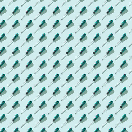 Hand screwdrivers with a green and black handle on a blue background. Hand tool for turning screws.