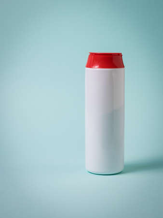 Cleaning powder in a white plastic bottle on a blue background. Cleaning the house and office.の写真素材