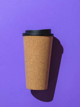 Paper coffee glass in hard light on a lilac background. A popular hot drink.の写真素材