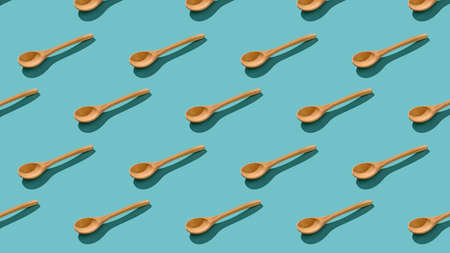 Seamless pattern of wooden spoons on a blue background. Wooden Cutlery.の写真素材