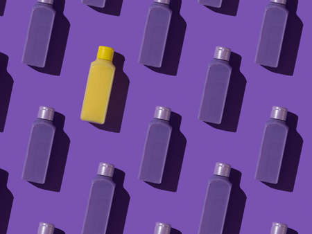 Seamless pattern of purple plastic bottles and one yellow one on a purple background. Cosmetic product in a plastic bottle.の写真素材