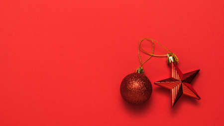 Red Christmas toys on a bright red background. Meeting of Christmas and new year.