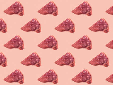 Seamless pattern made of pieces of beef on a pink background. A fresh piece of meat.の写真素材