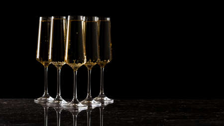 Group of wine glasses on a stone table on a black background. A popular alcoholic drink.の写真素材