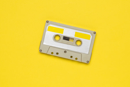 Vintage tape recorder on a yellow background. Vintage audio recording storage and playback tools.の写真素材