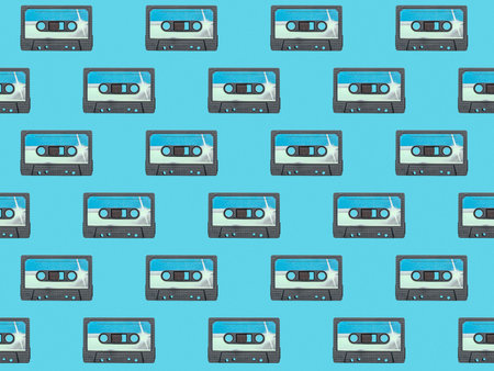 Seamless pattern of blue cassettes on a blue background. Retro carrier of audio information.の写真素材