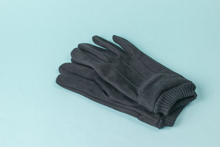 brutal men's leather gloves on a blue background. Men's accessory for cool weather.
