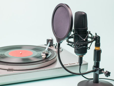 Modern microphone on the background of a vinyl DISC player. Record and play audio.の写真素材
