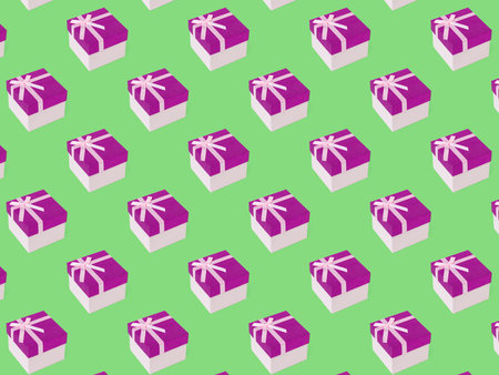 Closed gift box with a bow on a green background. Packaging for a gift.の写真素材