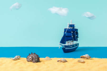 Installation of a sailboat moored to a sandy beach with seashells. The concept of travel and...