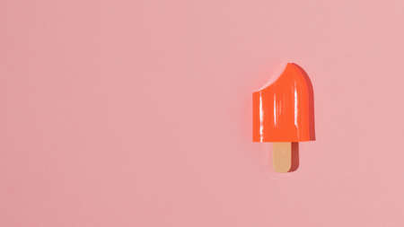 Red frozen juice on a stick on a red background. A popular summer snack.の写真素材