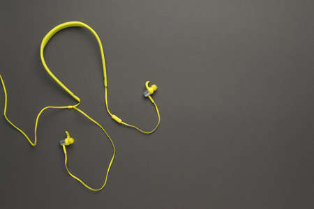 Stylish yellow headphones on a dark gray background. Equipment for listening to music.の写真素材
