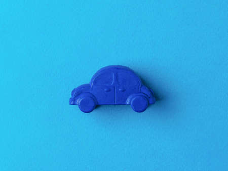 Dark blue car on a light blue background. The concept of selling and buying cars.の写真素材