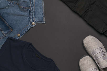 A set of men's casual clothing and sneakers on a black background. Fashionable youth casual clothing. Flat lay.の写真素材