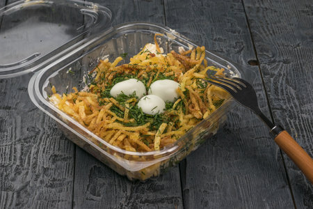 Salad in the form of a nest in a container for safe delivery. Safe cooking.