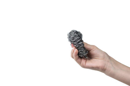 Female hand with metal dish brush isolated on white background. An item for cleaning the house.