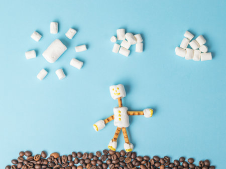 Marshmallow man with coffee beans and marshmallow clouds. A collage of sweets. Flat lay.の写真素材