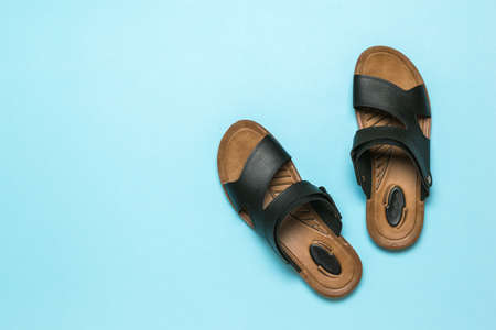 Men's leather sandals on a light blue background. Summer men's shoes. Flat lay.の写真素材