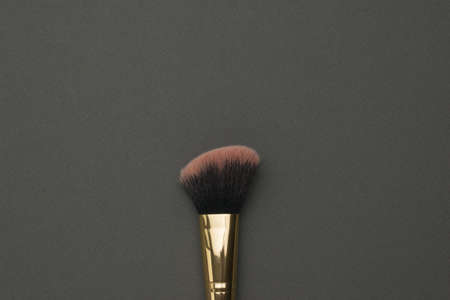Makeup brush with red bristles on a black background. Facial care.の写真素材