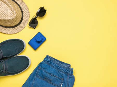 Men's accessories for leisure and travel on a yellow background. Space for the text. Flat lay.の写真素材