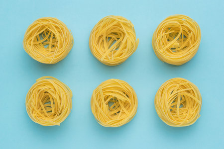 A popular type of pasta on a light blue background. Products made of durum wheat.