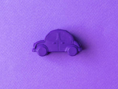 Purple retro car toy on a purple background. The concept of selling and buying cars.の写真素材
