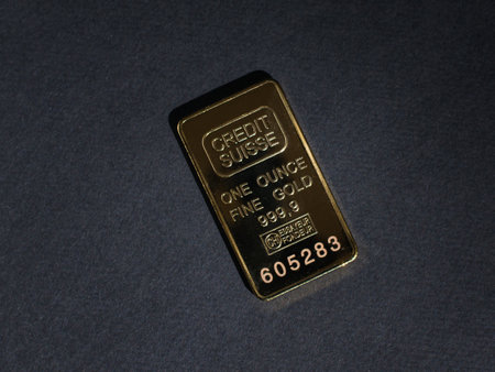 A gold bar on a black background. Precious metal. Flat lay.の写真素材