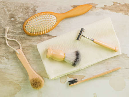 Shaving supplies, a toothbrush and combs on a towel on a wooden table. Hygiene.Spa. Flat lay.の写真素材