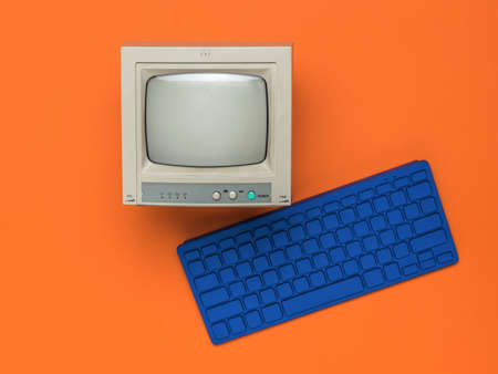 Stylish blue keyboard and a small monitor on an orange background. Vintage equipment.の写真素材