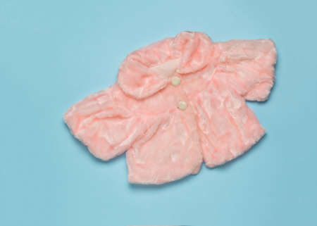 Stylish women's pink fur cape on a blue background. Stylish women's fur clothing. Flat lay.の写真素材
