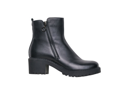 Left leather women's half-boots with high heels isolated on a white background. Fashionable women's shoes.の写真素材