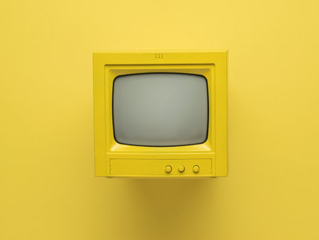 Yellow retro monitor with a ray tube on a yellow background. Retro equipment. Flat lay.の写真素材