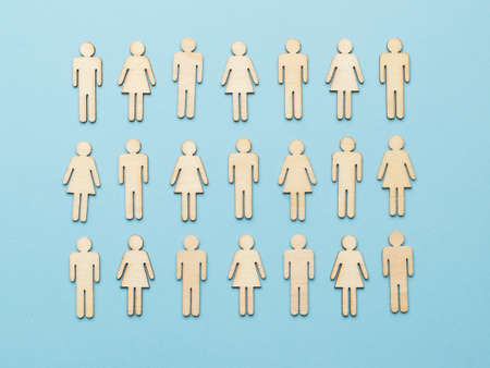 A large group of wooden men on a blue background. Community concept.の写真素材