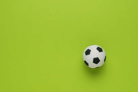Top view of a soccer ball on a green background. The concept of the popular ball game. Flat lay.の写真素材