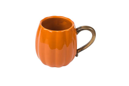 Orange ceramic mug isolated on a white background. Pumpkin style.の写真素材