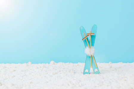 Beautiful blue ice skating toys on a two-tone blue background. Winter sports.