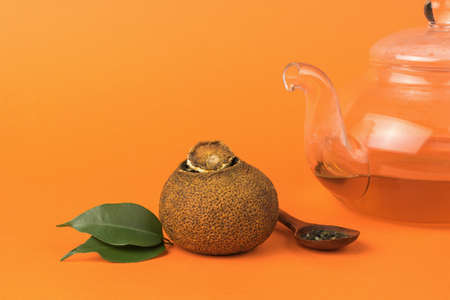 Tea in a teapot and dried orange with dry tea. Tea drink with citrus fruits and fruits.の写真素材