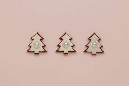 Three creative wooden figures of a fir tree on a pastel background. The minimum concept of the New Year. Christmas tree. Contemporary art.の写真素材