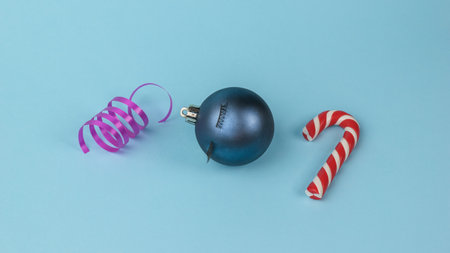 Creative balloon, serpentine and New Year's sweetness on a blue background. Minimalism. Contemporary art. The concept of the New Year.の写真素材